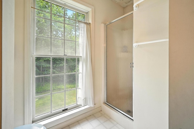 15 Loon Call Dr, Belgrade, ME 04917 - full bathroom with healthy amount of natural light, a stall shower, and tile patterned floors