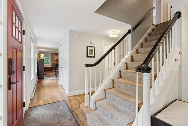 3 Flintlock Ln, Falmouth, ME 04105 - foyer with stairway, wood finished floors, and baseboard heating