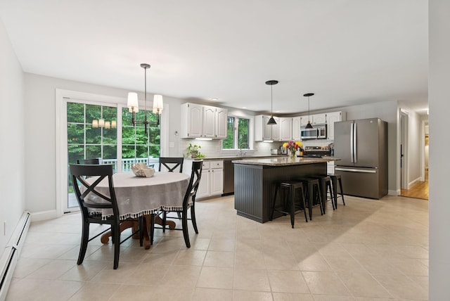 3 Flintlock Ln, Falmouth, ME 04105 - dining room with baseboard heating, light tile patterned floors, and a chandelier