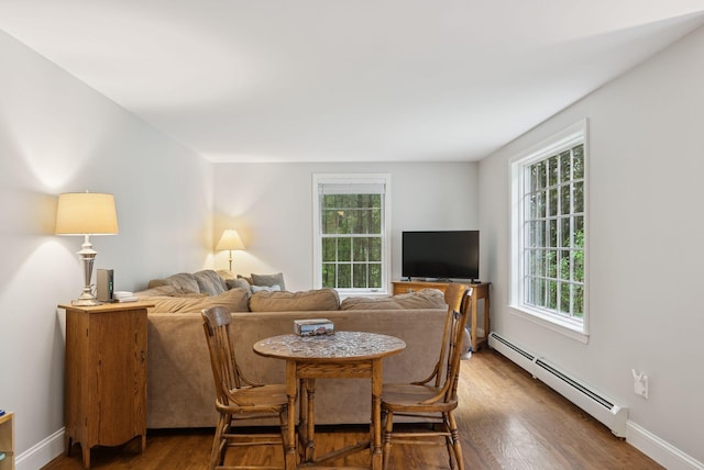 3 Flintlock Ln, Falmouth, ME 04105 - dining area featuring baseboard heating, plenty of natural light, and wood finished floors