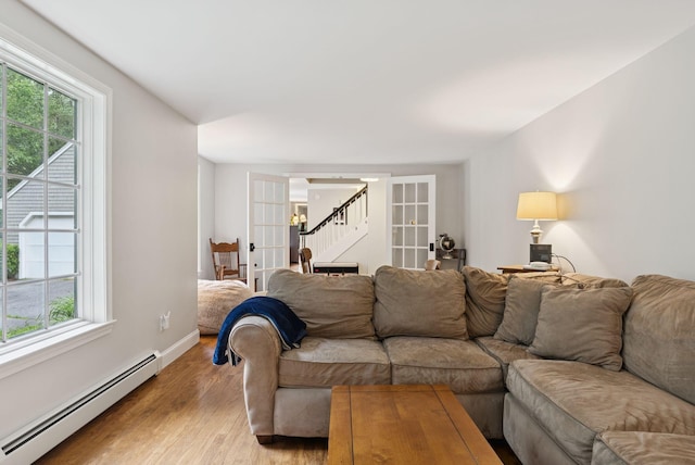3 Flintlock Ln, Falmouth, ME 04105 - living room with baseboard heating, french doors, healthy amount of natural light, and light wood-style flooring