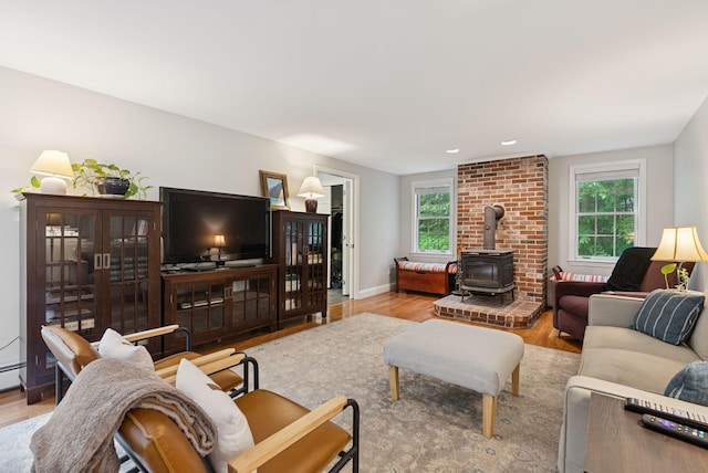 3 Flintlock Ln, Falmouth, ME 04105 - living room with a wood stove, plenty of natural light, wood finished floors, and recessed lighting