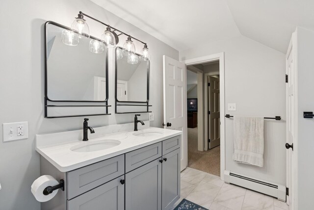 3 Flintlock Ln, Falmouth, ME 04105 - bathroom featuring baseboard heating, lofted ceiling, double vanity, and marble look tiles