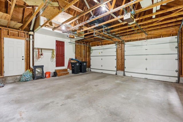3 Flintlock Ln, Falmouth, ME 04105 - garage featuring a garage door opener and a wood stove