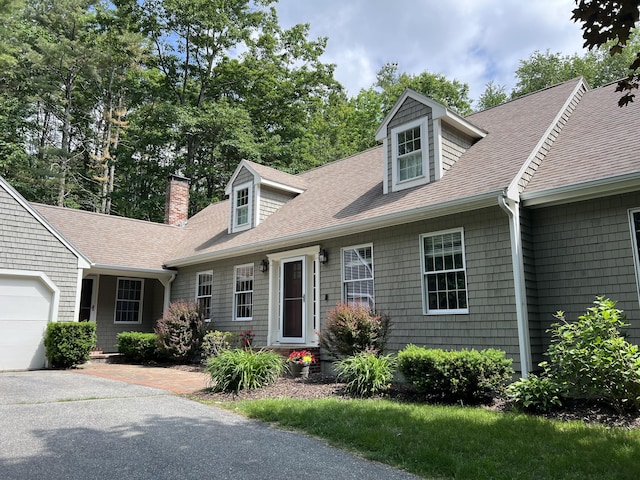 3 Flintlock Ln, Falmouth, ME 04105 - cape cod-style house with a shingled roof, a chimney, and an attached garage