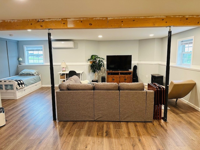 905 Blackstream Rd, Hermon, ME 04401 - living room featuring a wall unit AC, wood finished floors, plenty of natural light, recessed lighting, and beam ceiling