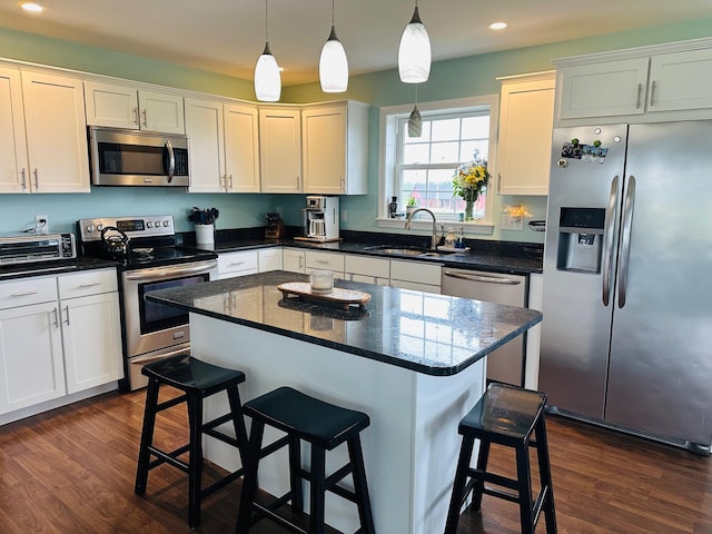 905 Blackstream Rd, Hermon, ME 04401 - kitchen featuring stainless steel appliances, a breakfast bar, recessed lighting, dark wood-style floors, and white cabinetry