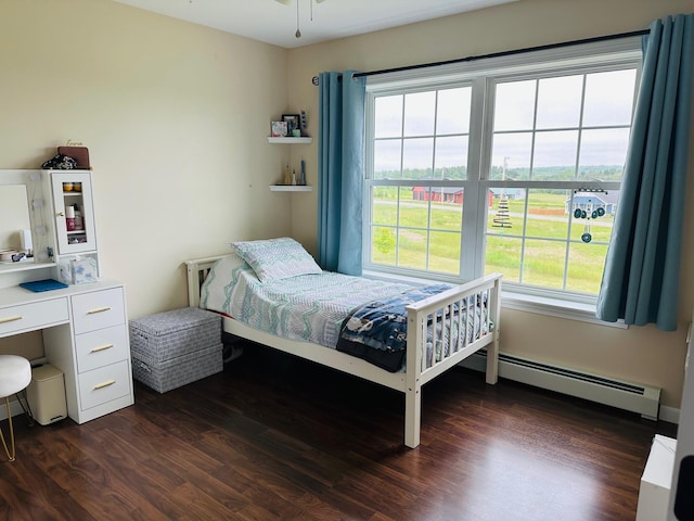 905 Blackstream Rd, Hermon, ME 04401 - bedroom featuring a baseboard heating unit and dark wood-style floors