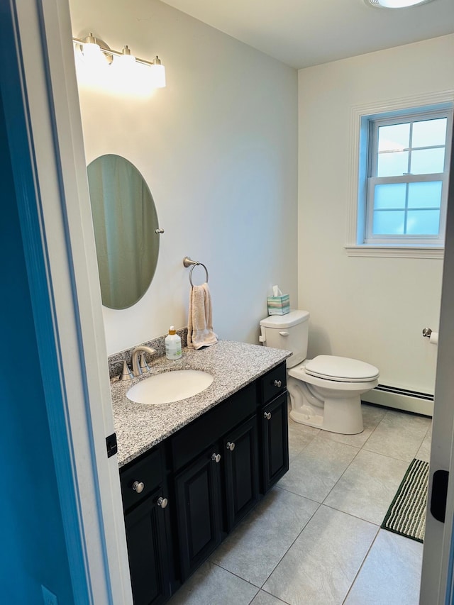 905 Blackstream Rd, Hermon, ME 04401 - half bath with a baseboard radiator, vanity, and tile patterned flooring