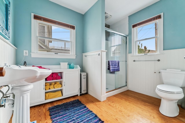 6 Fort Hill Ave, York, ME 03909 - full bathroom with a stall shower, a wainscoted wall, wood finished floors, and radiator heating unit