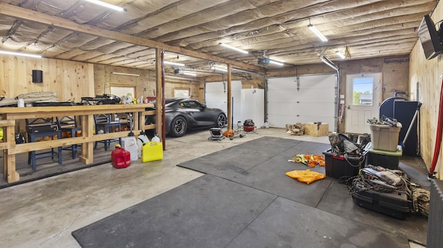 178 Potter Rd, Hudson, ME 04449 - garage featuring a garage door opener and a workshop area