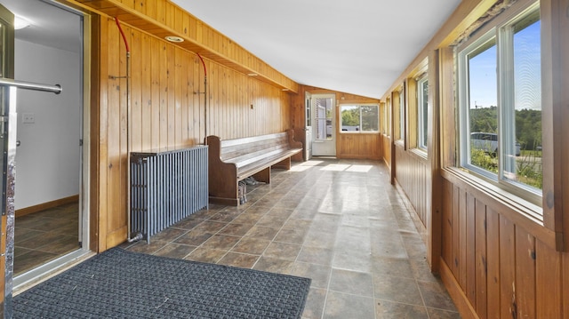 178 Potter Rd, Hudson, ME 04449 - unfurnished sunroom featuring wood walls, lofted ceiling, and stone finish flooring