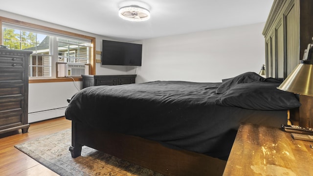 178 Potter Rd, Hudson, ME 04449 - bedroom featuring baseboard heating, cooling unit, and wood finished floors