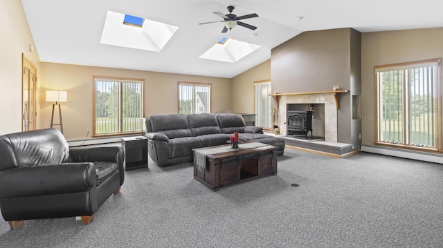 178 Potter Rd, Hudson, ME 04449 - living room with a wood stove, a skylight, carpet, vaulted ceiling, and ceiling fan