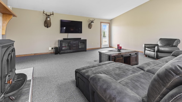 178 Potter Rd, Hudson, ME 04449 - carpeted living area featuring a wood stove and vaulted ceiling