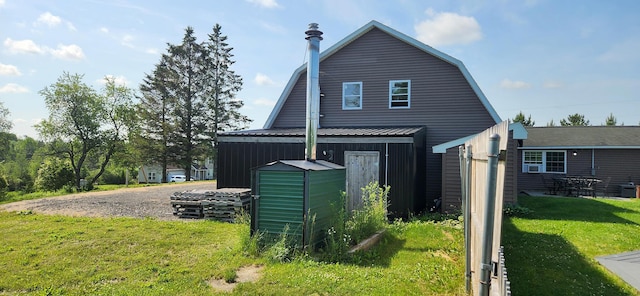 178 Potter Rd, Hudson, ME 04449 - view of side of home featuring a gambrel roof, a lawn, and board and batten siding