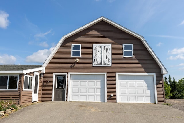 178 Potter Rd, Hudson, ME 04449 - view of home's exterior featuring a garage, a gambrel roof, and an outbuilding