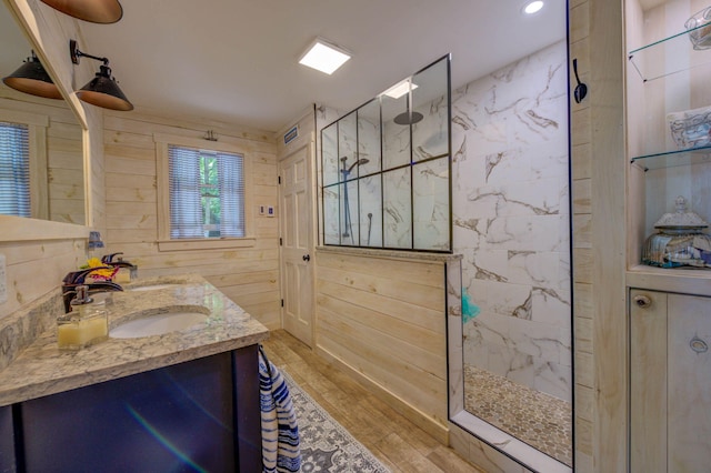 147 Spring Valley Rd, Raymond, ME 04071 - full bathroom with wooden walls, wood finished floors, double vanity, and walk in shower