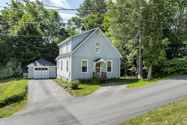 8 Riverview Ave, Lewiston, ME 04240 - view of front of house with an outbuilding, asphalt driveway, a garage, and a chimney