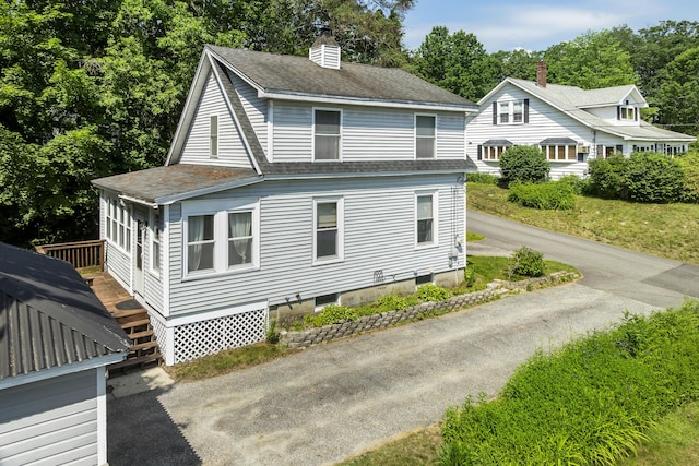 8 Riverview Ave, Lewiston, ME 04240 - view of side of home featuring a shingled roof, a chimney, and a deck