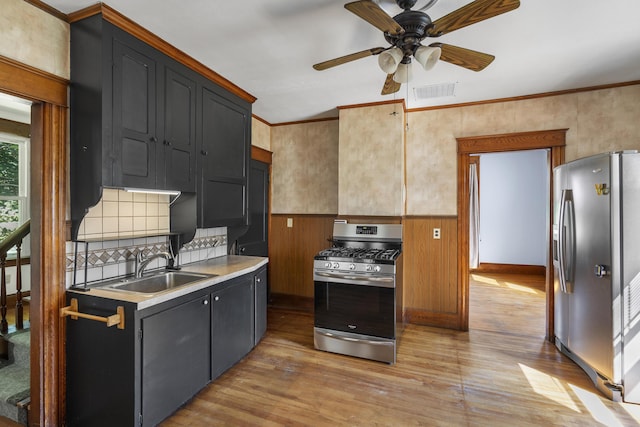 8 Riverview Ave, Lewiston, ME 04240 - kitchen featuring stainless steel appliances, light wood-style floors, a ceiling fan, crown molding, and light countertops