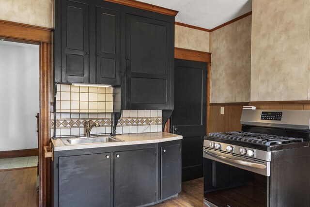 8 Riverview Ave, Lewiston, ME 04240 - kitchen with stainless steel range with gas cooktop, dark wood-style flooring, decorative backsplash, crown molding, and dark cabinets