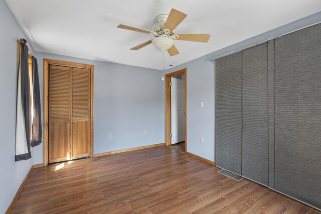 8 Riverview Ave, Lewiston, ME 04240 - unfurnished bedroom with wood finished floors, ceiling fan, and a closet