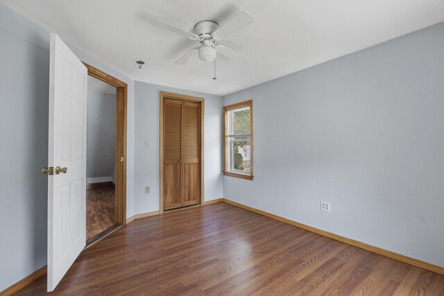 8 Riverview Ave, Lewiston, ME 04240 - unfurnished bedroom with wood finished floors, a closet, and a ceiling fan