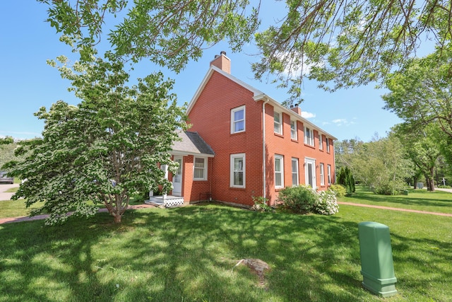 1 Ephraim Tyler Way Unit 1, Kennebunk, ME 04043 - view of front of house featuring a chimney, brick siding, and a front yard