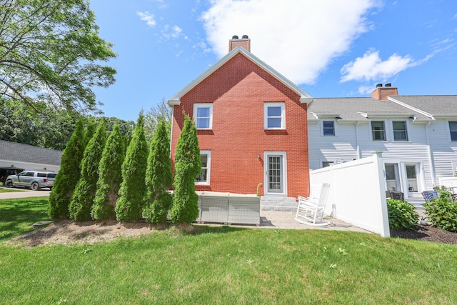 1 Ephraim Tyler Way Unit 1, Kennebunk, ME 04043 - back of property with a patio area, brick siding, an outdoor hangout area, entry steps, and a chimney
