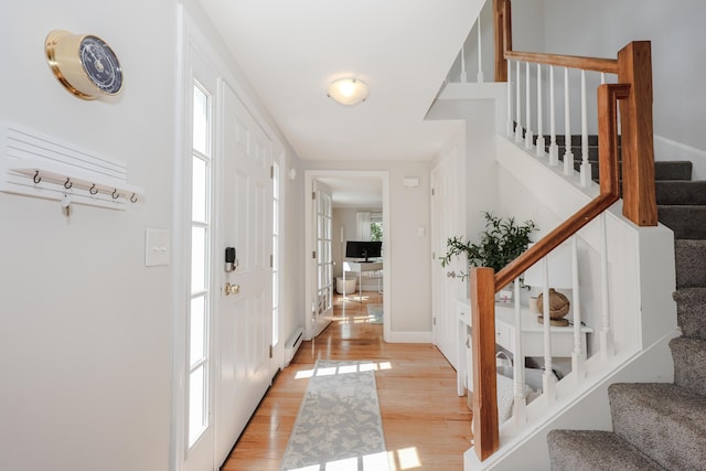 1 Ephraim Tyler Way Unit 1, Kennebunk, ME 04043 - foyer entrance featuring stairs, light wood-style floors, and a baseboard radiator