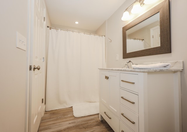 1 Ephraim Tyler Way Unit 1, Kennebunk, ME 04043 - bathroom featuring vanity, wood finished floors, and recessed lighting