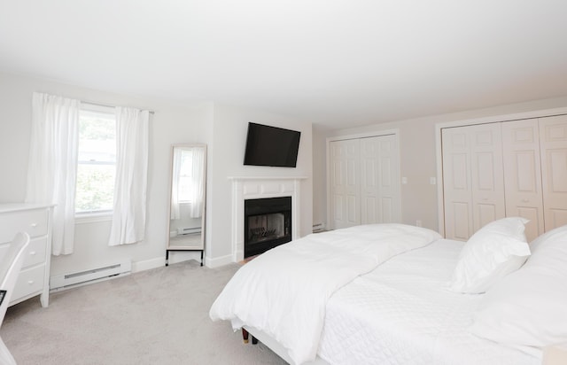 1 Ephraim Tyler Way Unit 1, Kennebunk, ME 04043 - bedroom with a baseboard radiator, two closets, carpet floors, and a fireplace