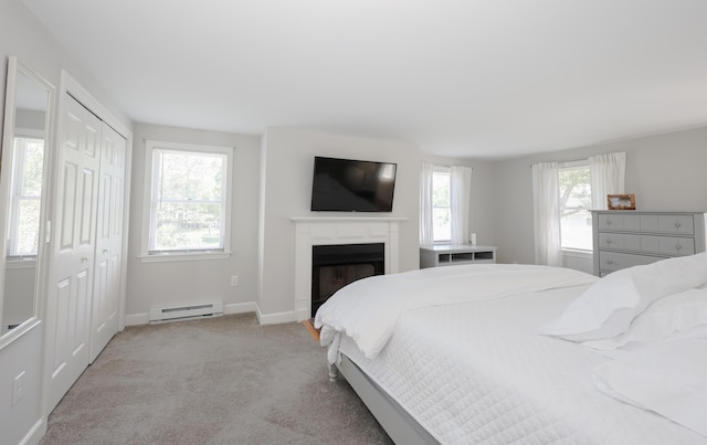 1 Ephraim Tyler Way Unit 1, Kennebunk, ME 04043 - bedroom with a baseboard radiator, light colored carpet, and a fireplace