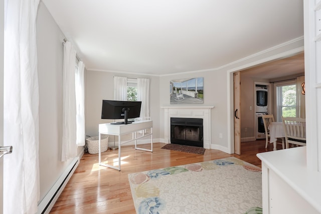 1 Ephraim Tyler Way Unit 1, Kennebunk, ME 04043 - living room with a baseboard heating unit, a fireplace with flush hearth, light wood-style flooring, and crown molding