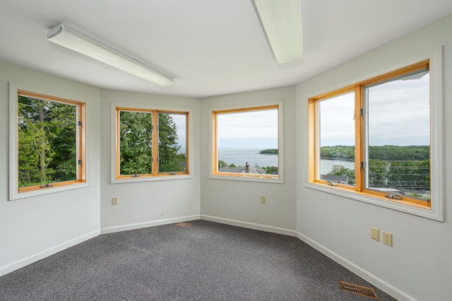 34 Old County Rd, Rockport, ME 04841 - empty room featuring a water view and dark colored carpet