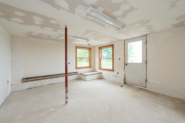 34 Old County Rd, Rockport, ME 04841 - spare room with a baseboard heating unit and unfinished concrete flooring