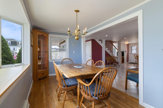 511 Webhannet Dr, Wells, ME 04090 - dining room featuring stairway, a chandelier, ornamental molding, and light wood-type flooring