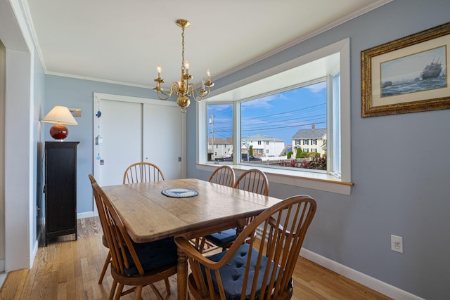 511 Webhannet Dr, Wells, ME 04090 - dining space with a chandelier, wood finished floors, and crown molding