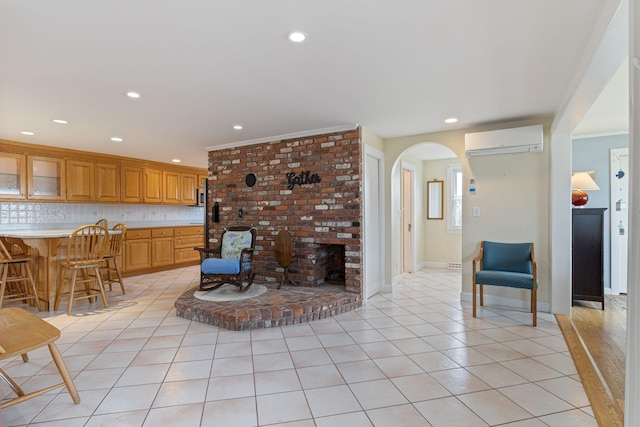 511 Webhannet Dr, Wells, ME 04090 - living room with an AC wall unit, arched walkways, light tile patterned flooring, crown molding, and recessed lighting