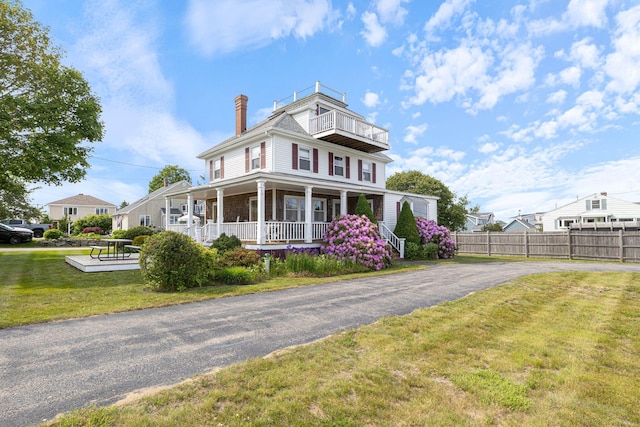 511 Webhannet Dr, Wells, ME 04090 - view of front of home with covered porch, a chimney, a balcony, and driveway