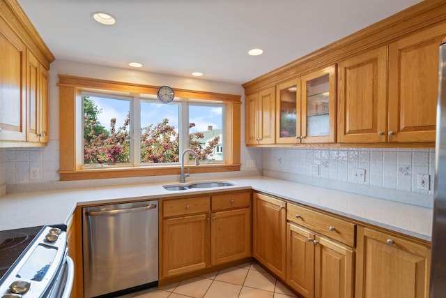511 Webhannet Dr, Wells, ME 04090 - kitchen with stainless steel appliances, light countertops, glass insert cabinets, light tile patterned flooring, and recessed lighting