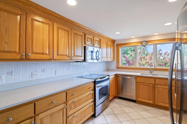 511 Webhannet Dr, Wells, ME 04090 - kitchen with stainless steel appliances, brown cabinetry, and recessed lighting