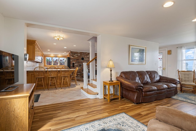 511 Webhannet Dr, Wells, ME 04090 - living room with stairs, light wood-type flooring, recessed lighting, and decorative columns