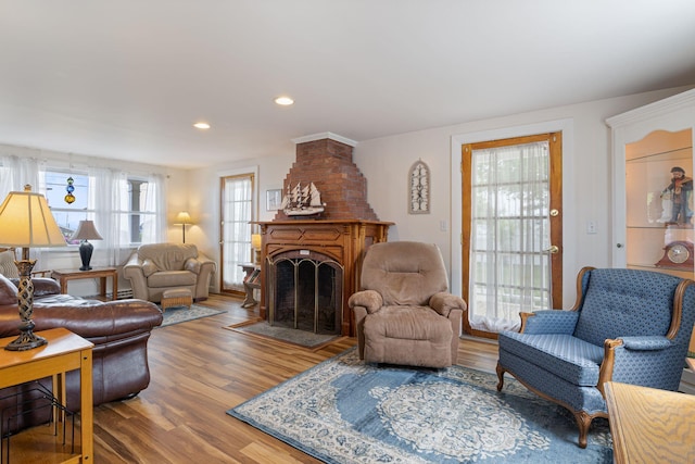 511 Webhannet Dr, Wells, ME 04090 - living room with wood finished floors, a fireplace with flush hearth, and recessed lighting