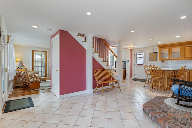 511 Webhannet Dr, Wells, ME 04090 - entryway featuring recessed lighting, stairs, light tile patterned floors, ornate columns, and bar area