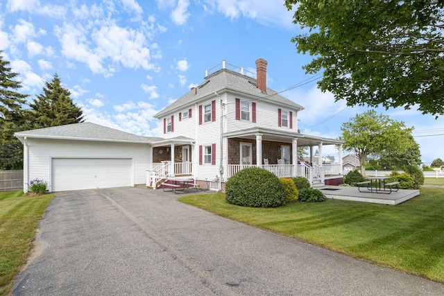511 Webhannet Dr, Wells, ME 04090 - view of front of property with a chimney, a garage, asphalt driveway, a front lawn, and roof with shingles