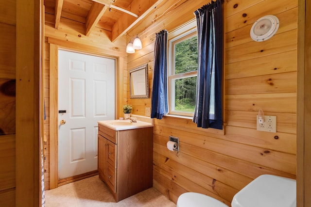660 Sprague Rd, Waldoboro, ME 04572 - bathroom featuring wood walls, healthy amount of natural light, a wooden ceiling with exposed beams, vanity, and tile patterned floors