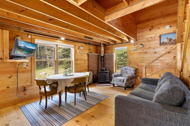 660 Sprague Rd, Waldoboro, ME 04572 - dining room featuring a wood stove, light wood-style floors, and wooden walls