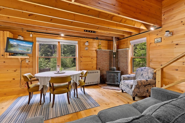 660 Sprague Rd, Waldoboro, ME 04572 - dining space featuring a wood stove, wooden walls, hardwood / wood-style flooring, and heating unit